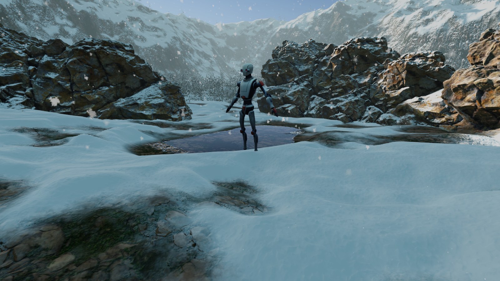 Forest demo: Robot Kyle next to the pond in the snowy clearing, between boulders, with the valley walls behind